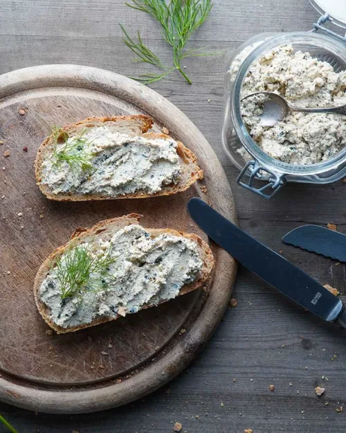 Hero Ansicht von der veganen Lachscreme auf zwei Broten. Dekoriert mit frischem Dill.