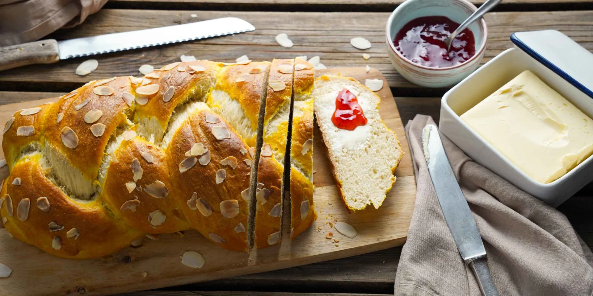 Easter braid on a board, with vegan butter and jam next to it