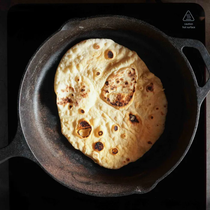 Vegan naan, step 4b, frying the naan in a cast iron pan
