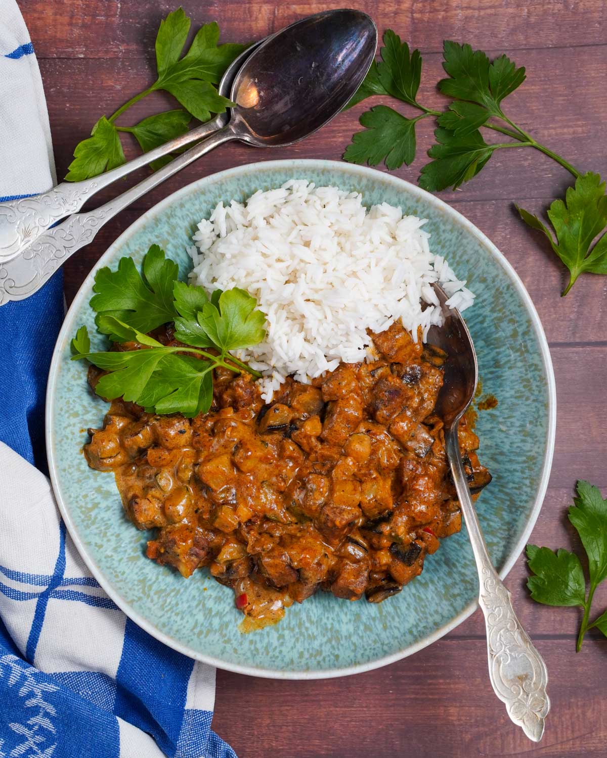 Veganes Tikka Masala im Teller, mit Reis und Koriander angerichtet, In der Draufsicht