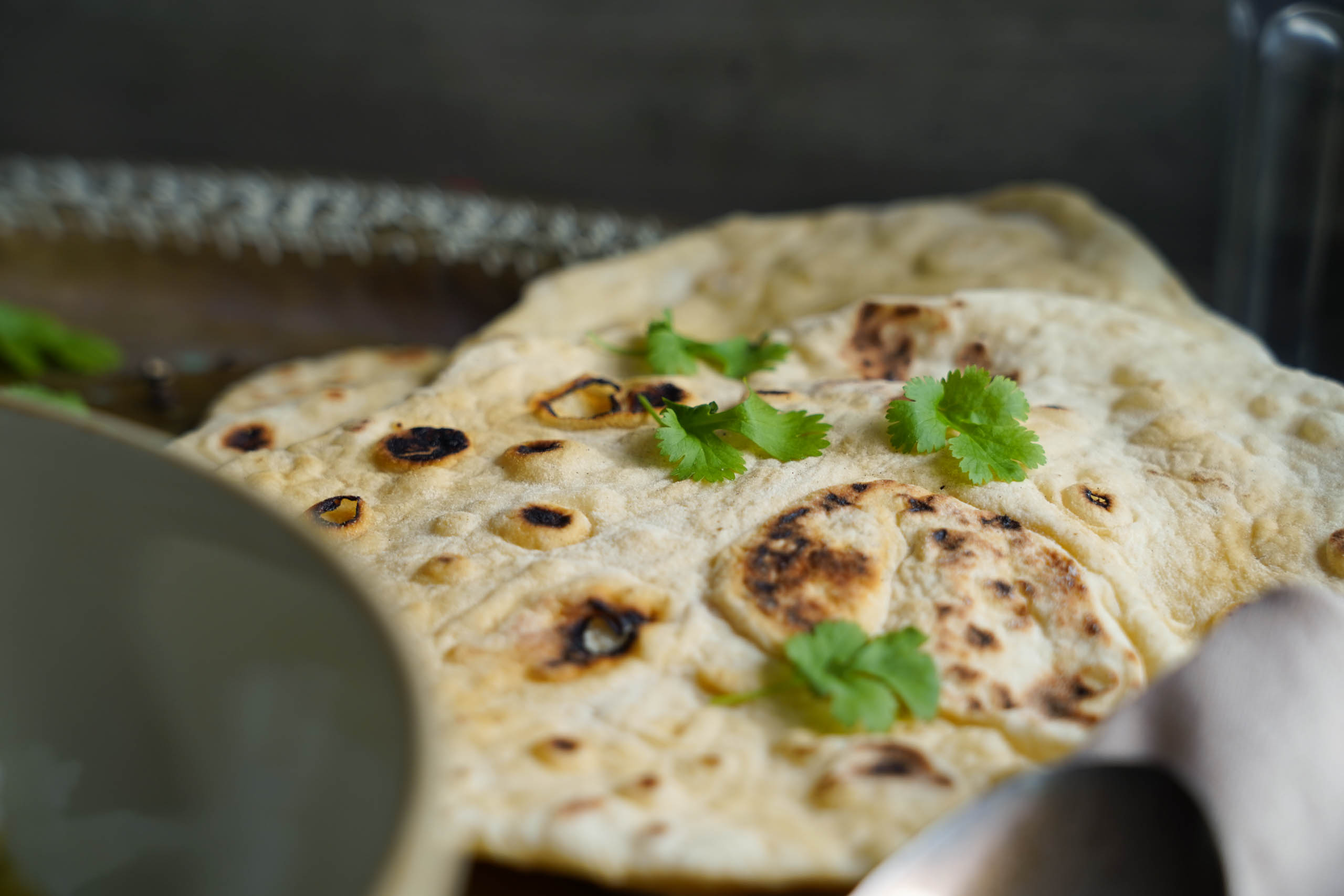 Detailaufnahme von Naanbrot. Dekoriert mit Koriander. Detailaufnahme von Naanbrot. Dekoriert mit Koriander.
